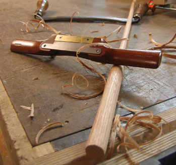 Wooden spokeshave on a woodworkers workbench